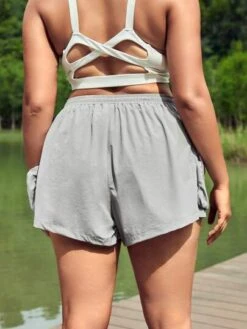 SHEIN Leisure Plus Drawstring Waist Sports Shorts With Phone Pocket